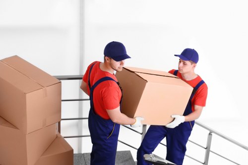 Removal team preparing moving boxes with safety equipment