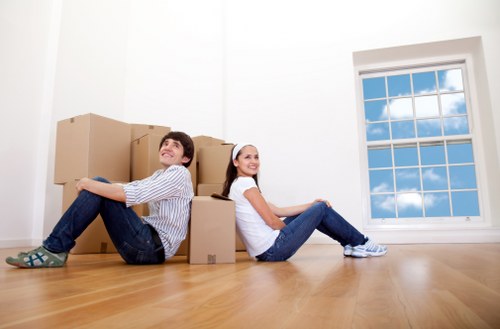 Professional movers transporting furniture in Brentford