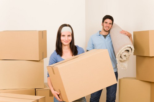 Family preparing for house removals in Brentford with packed moving boxes